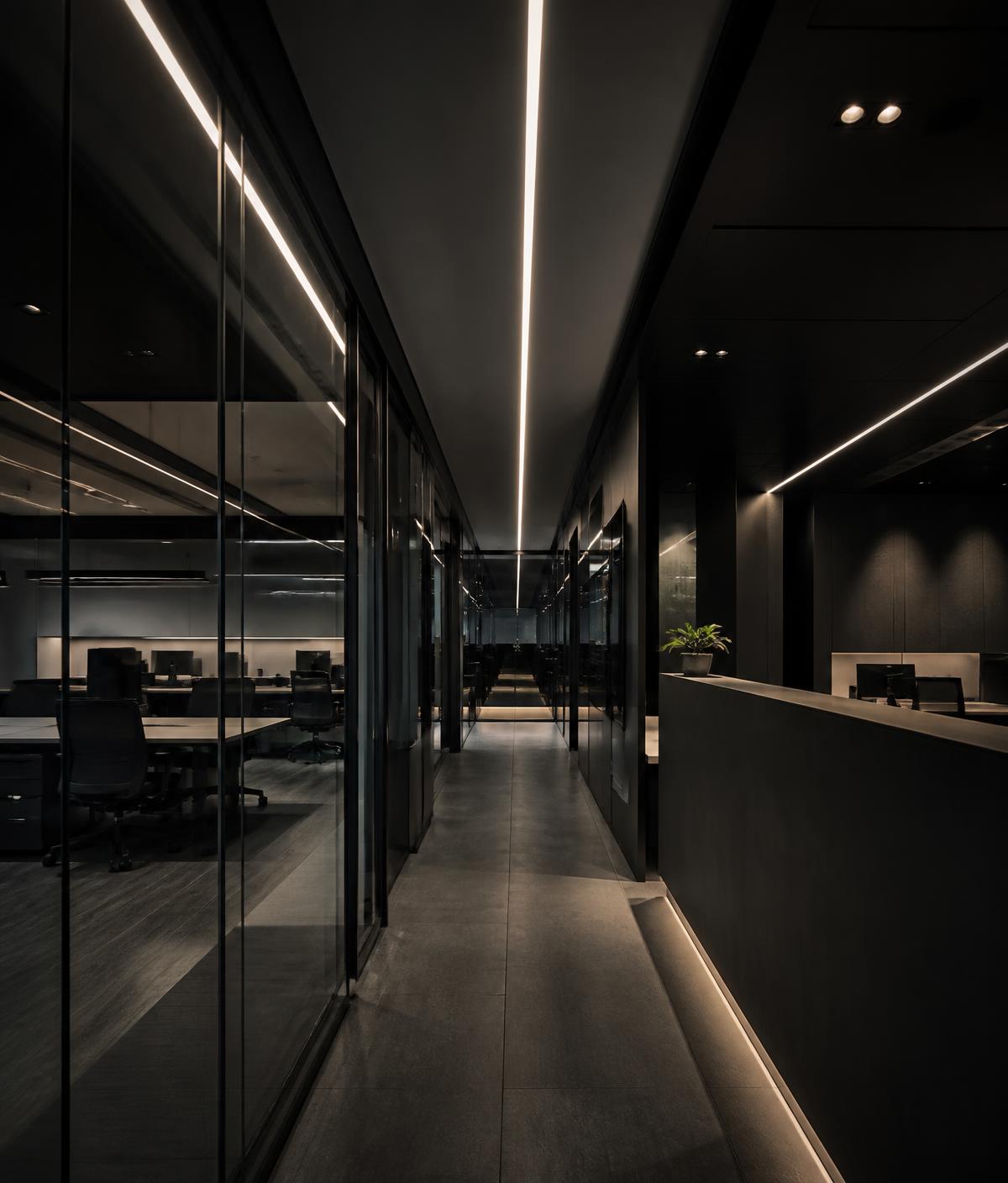 Modern commercial office fitout at night with linear ceiling lighting